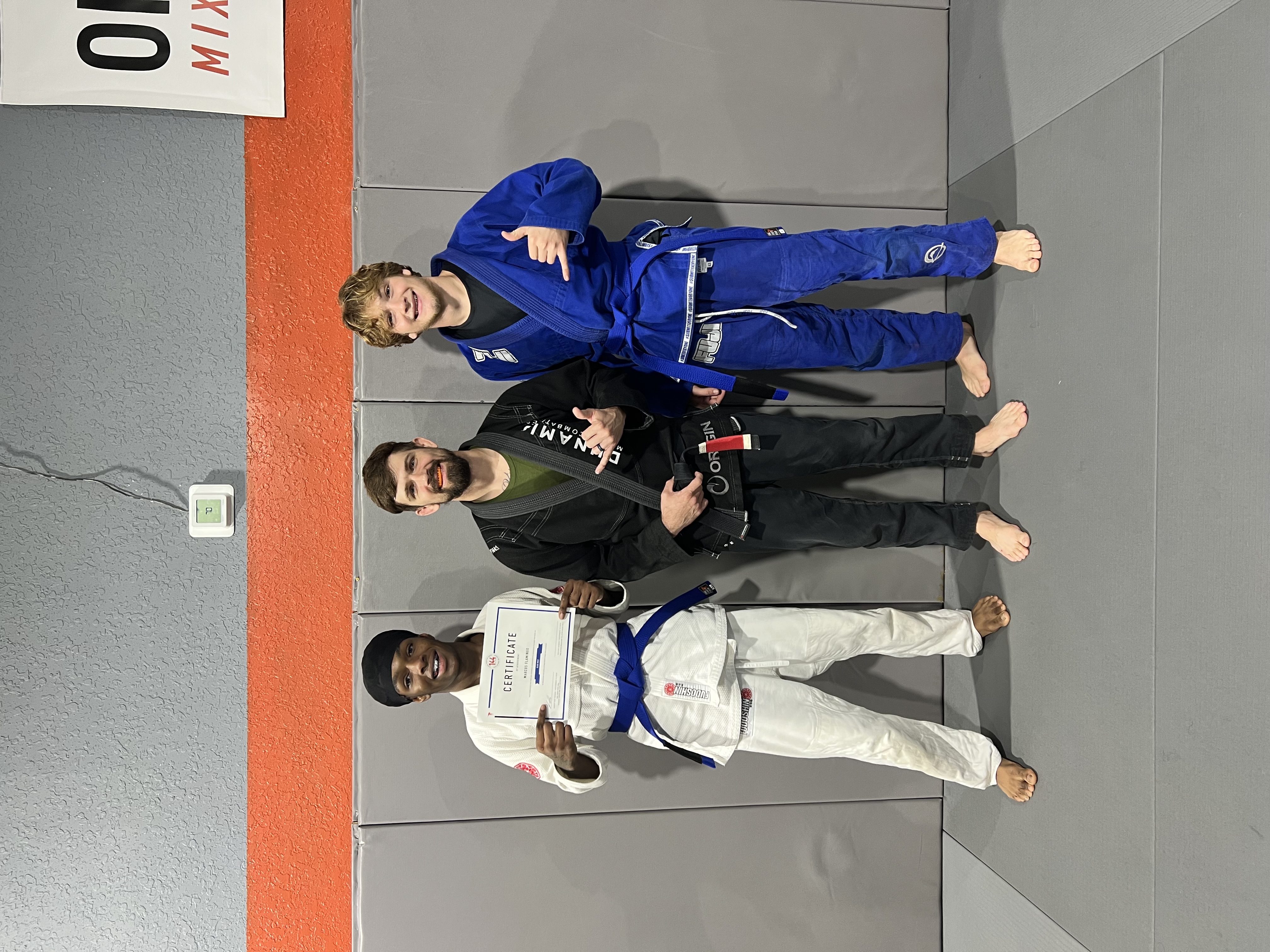 Owen at a jiu-jitsu gym with two training partners
