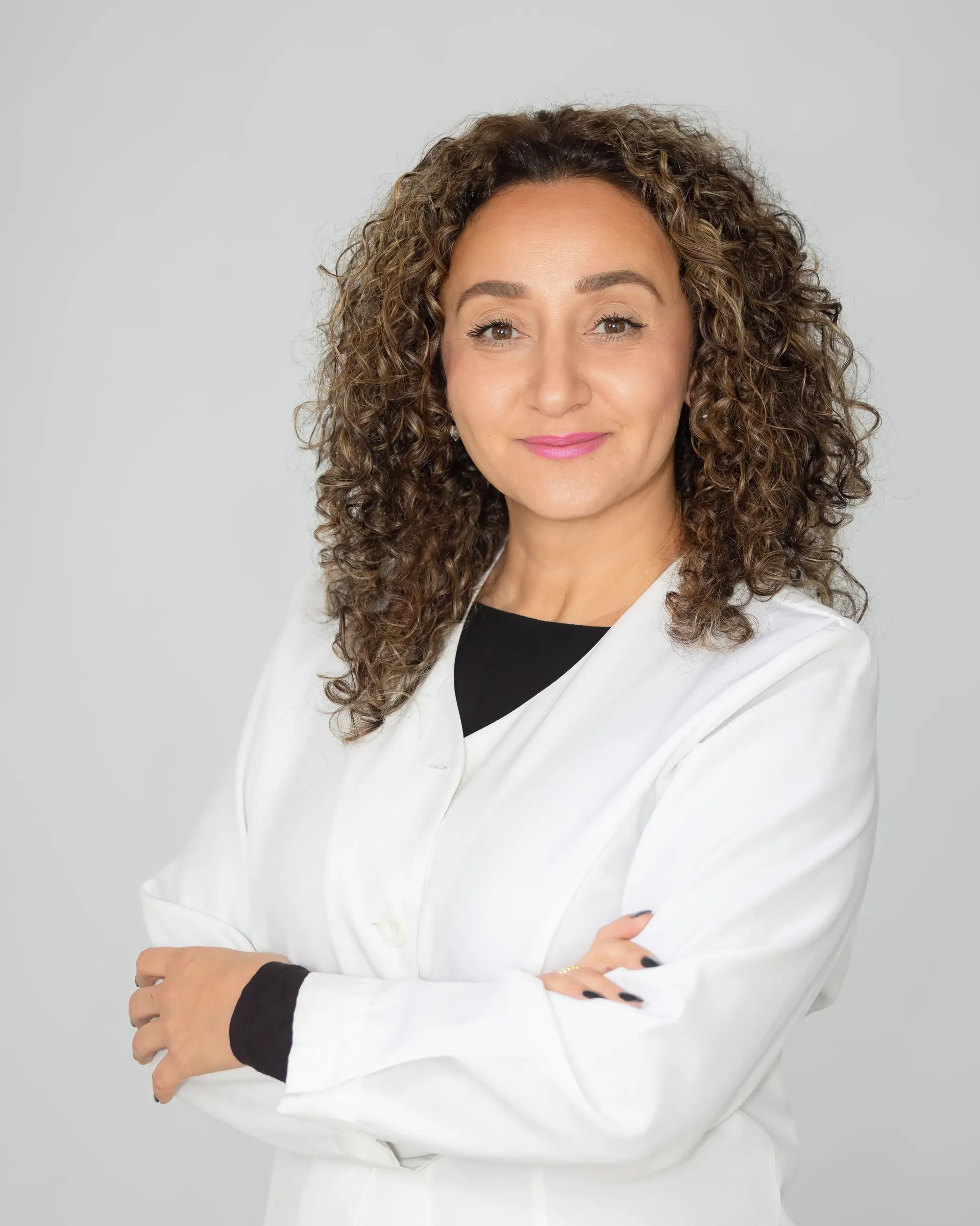A smiling pharmacist in a white coat