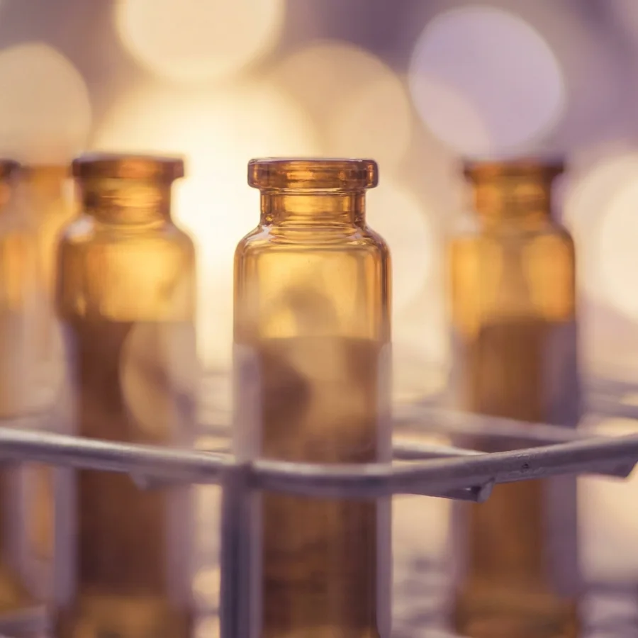 A row of empty vials arranged neatly on a laboratory rack, showcasing their clear glass structure.