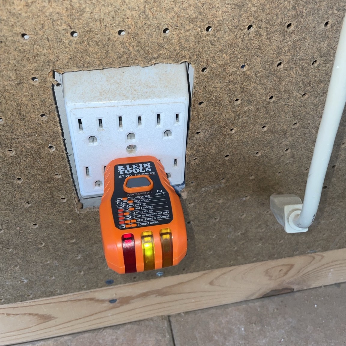 Outlet tester showing a reverse-polarity indication at a garage receptacle. Outlet tester showing a reverse-polarity indication at a garage receptacle.