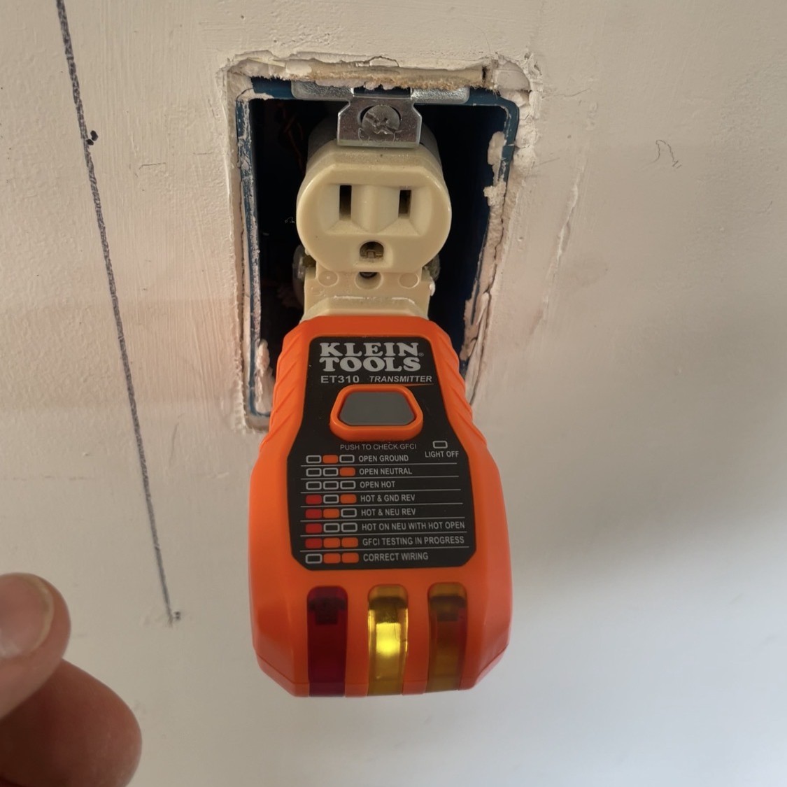 Outlet tester showing an open-ground indication at a garage receptacle. Outlet tester showing an open-ground indication at a garage receptacle.