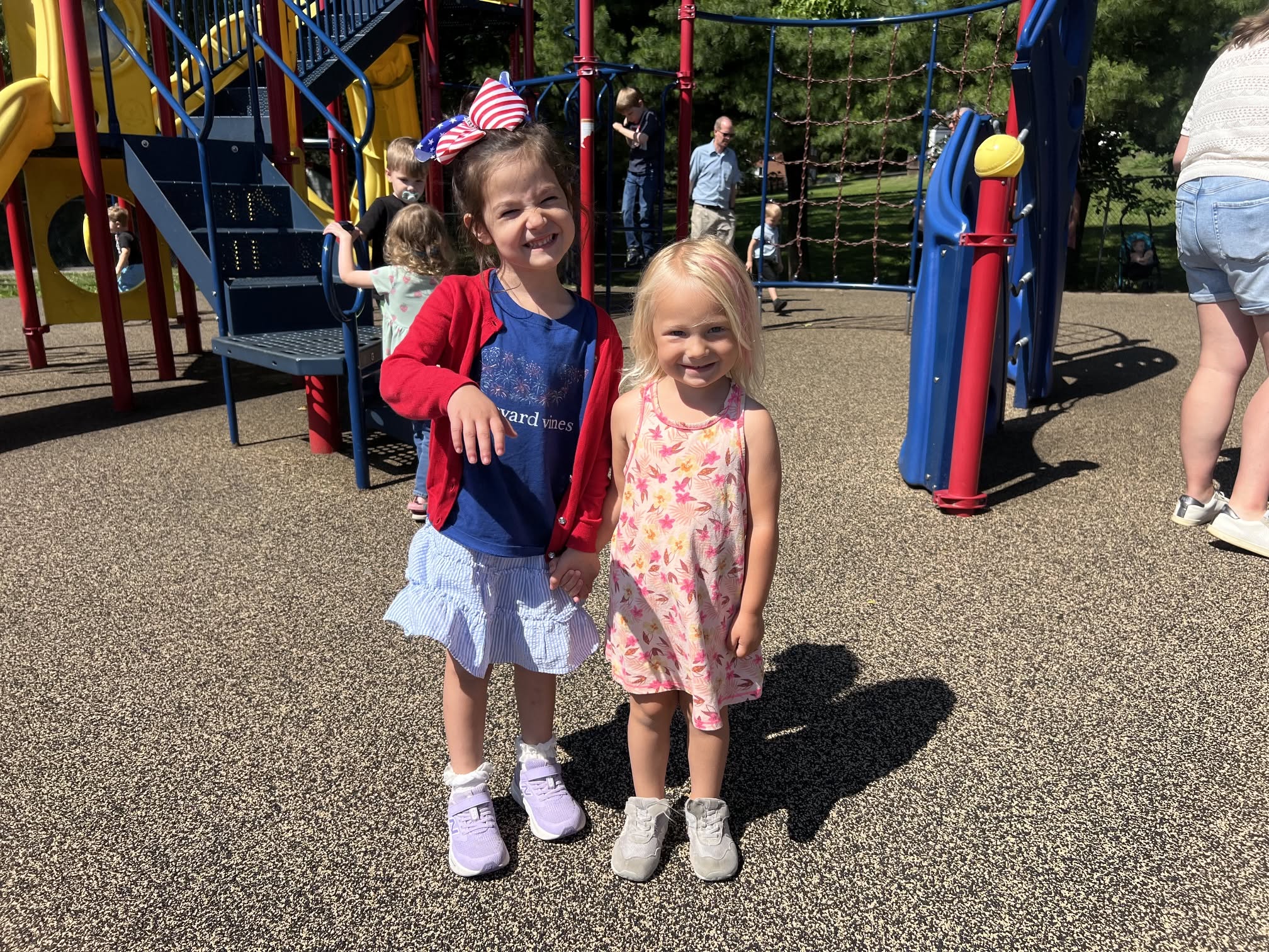 Two young parishioners, one wearing a flag hair bow