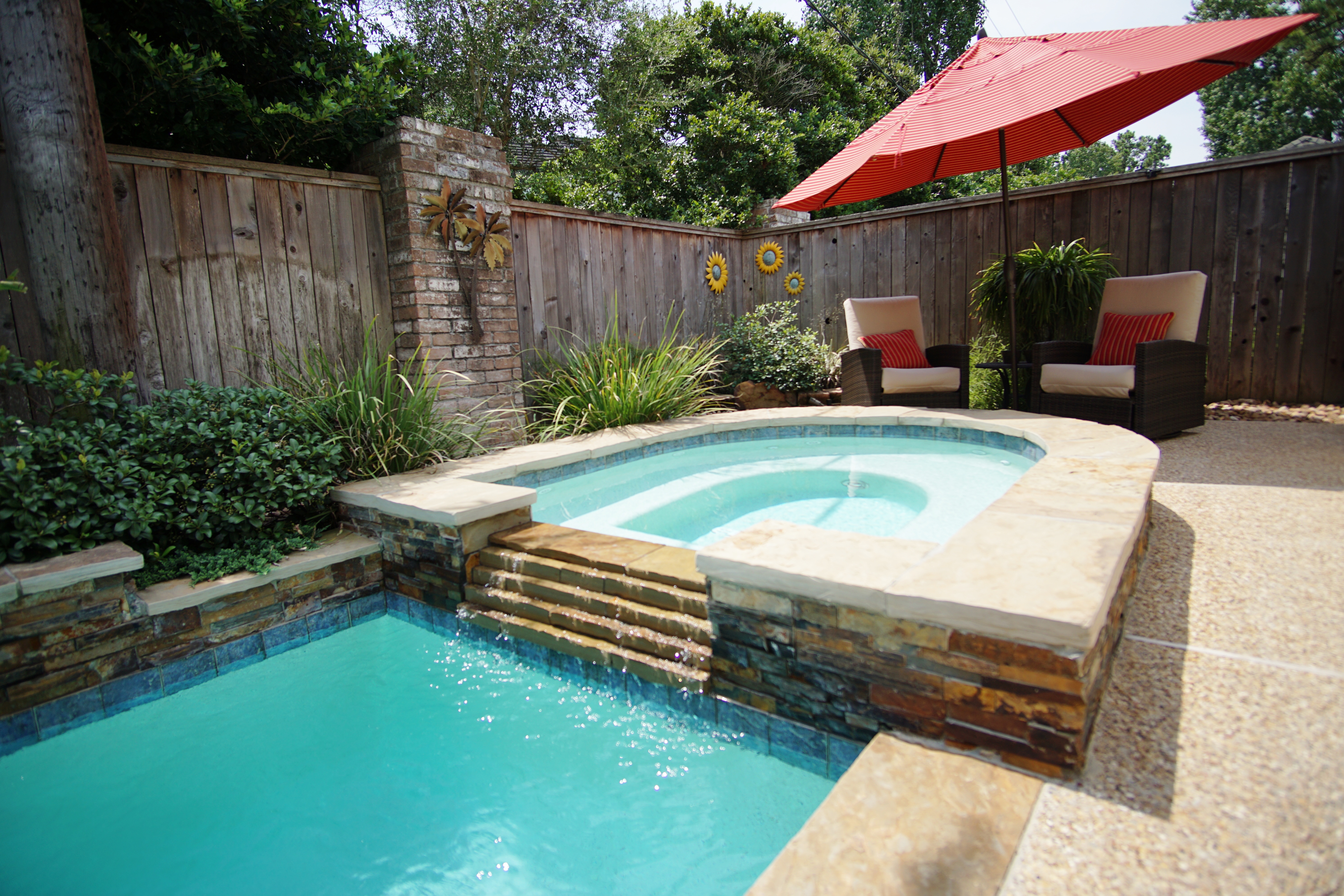 Freeform pool with rock waterfall in a Cypress, TX backyard