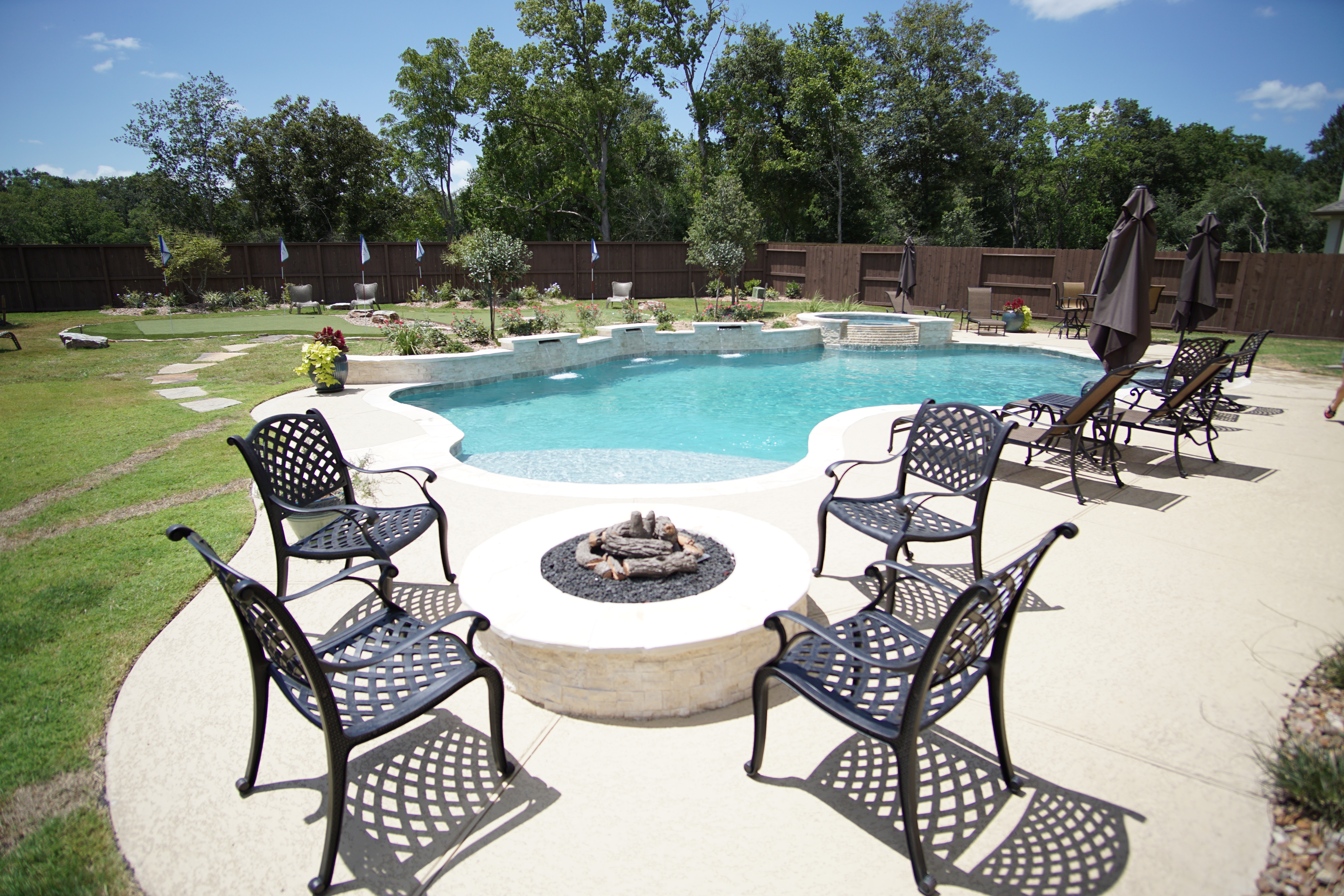 Complete outdoor living space with custom pool by Backyard Pool Specialists in Cypress, TX