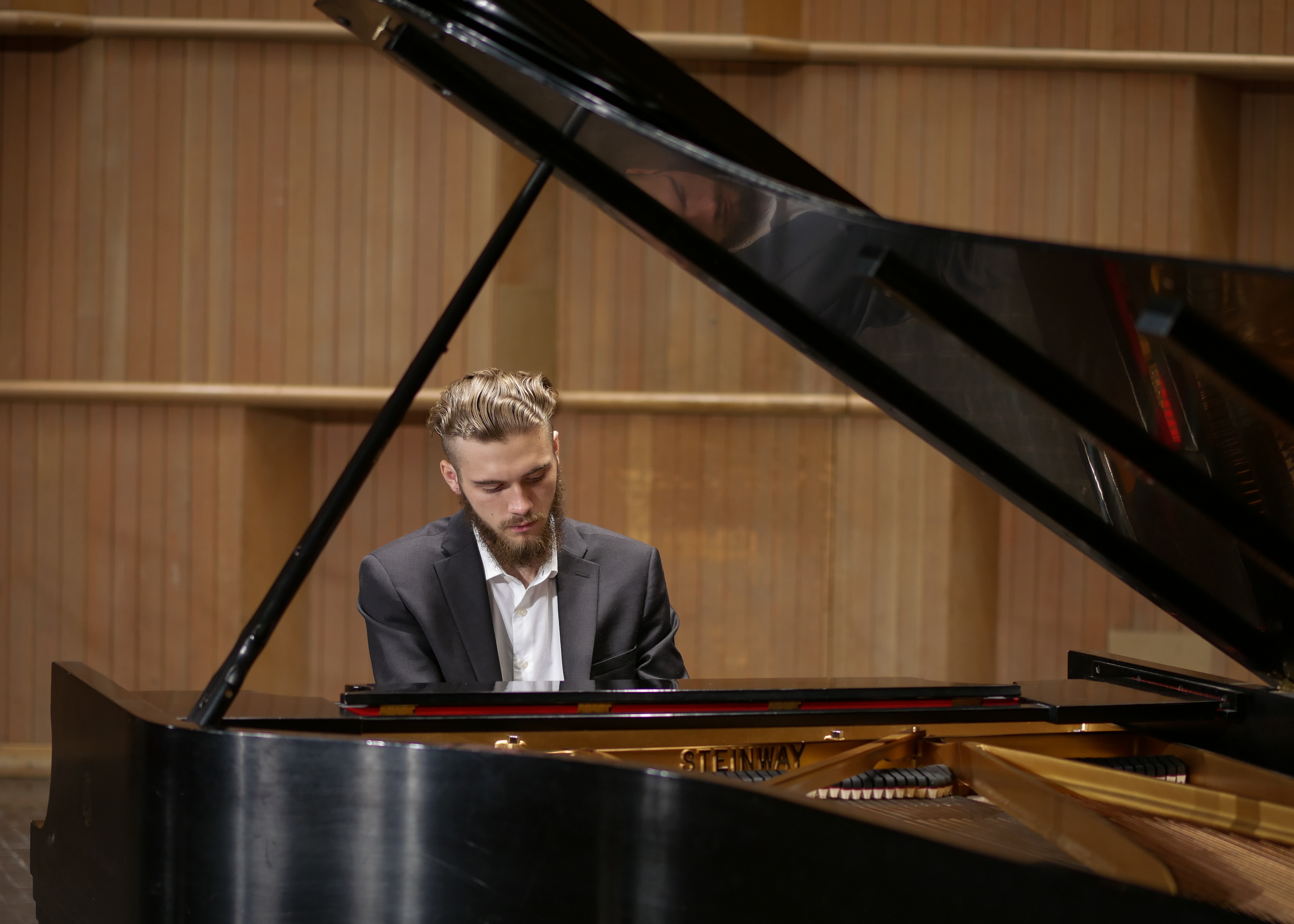 Jordan Green seated at a grand piano