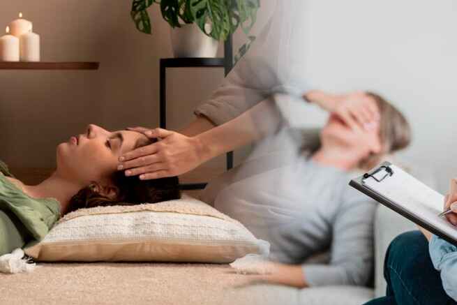 Hypnotherapist guiding client through relaxation, offering stress relief and emotional healing with hypnosis therapy.