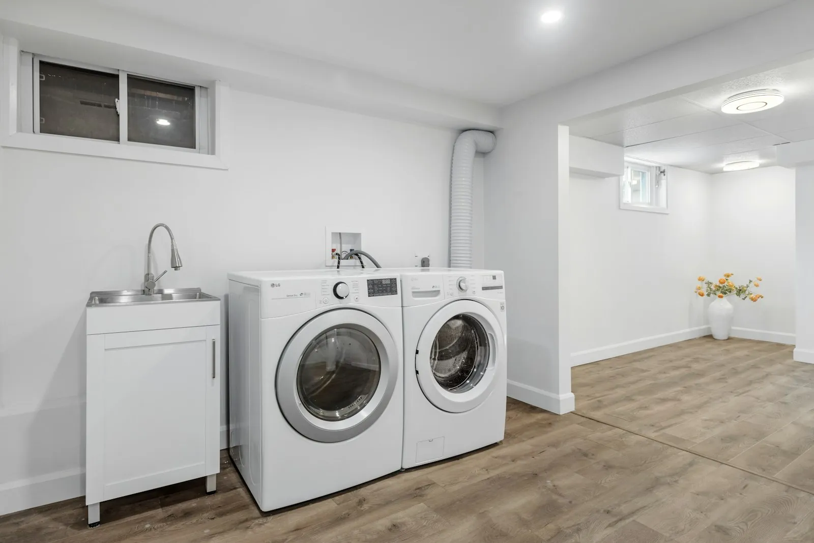 Representative stock photo of a washer and dryer pair in a laundry room