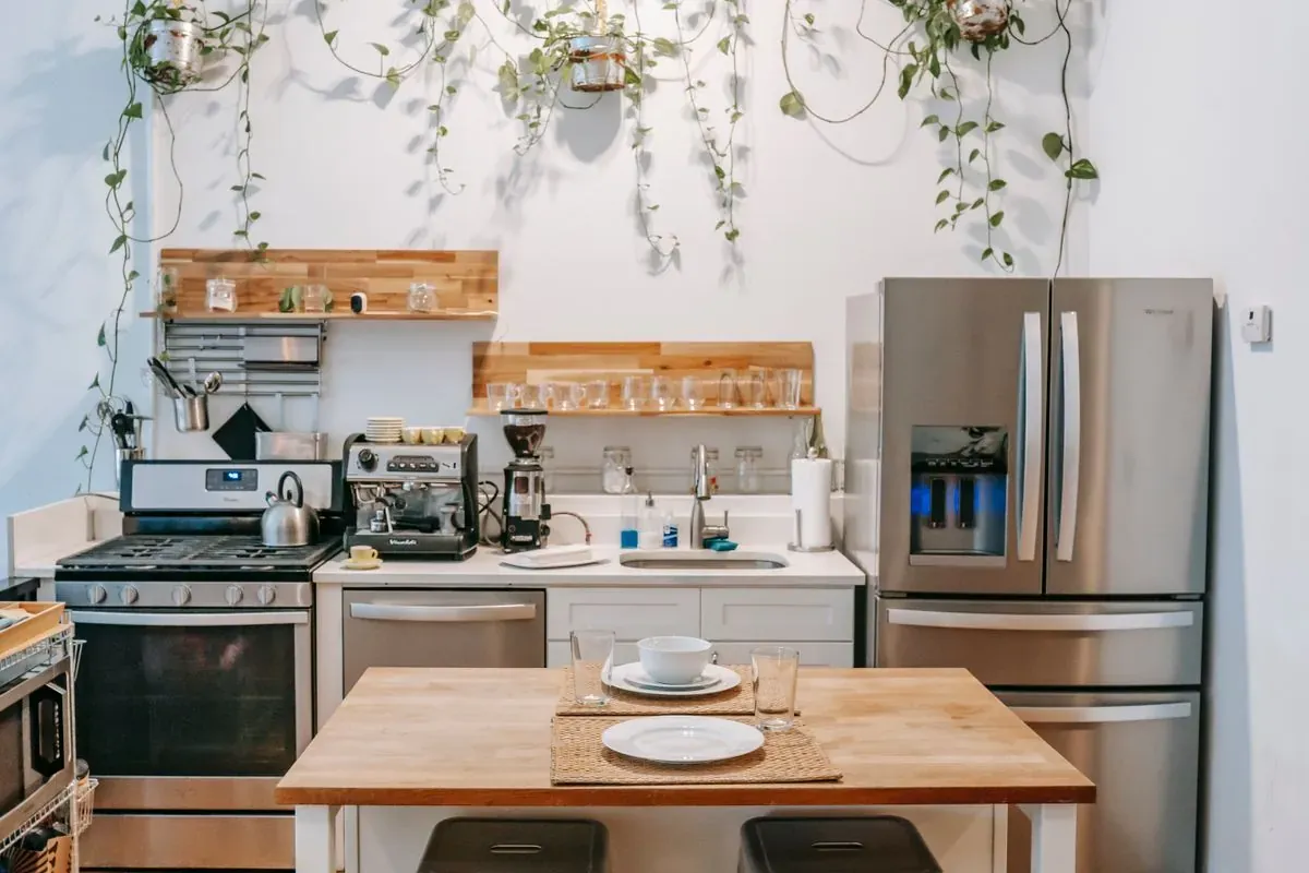 Representative stock photo of a bright kitchen with a stainless refrigerator