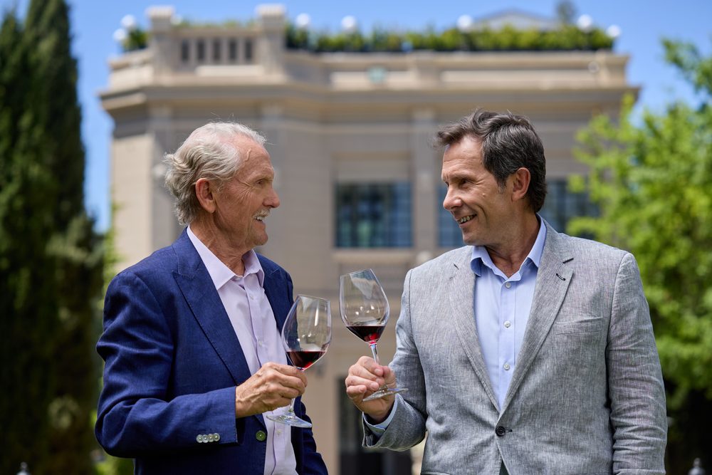 Alberto Arizu senior and Alberto Arizu junior raising a glass outside the Luigi Bosca winery