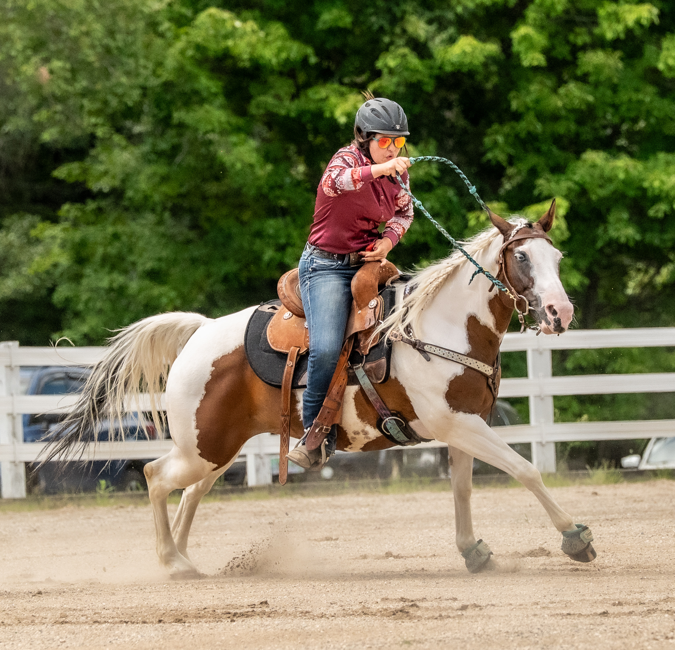 A bareback rider resting calmly on a dark horse in a sunlit Connecticut field, a quiet relaxed moment of horse and rider connection