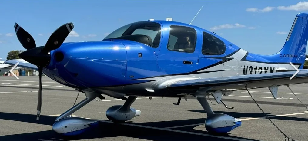 Single-engine aircraft with polished blue exterior finish parked on ramp