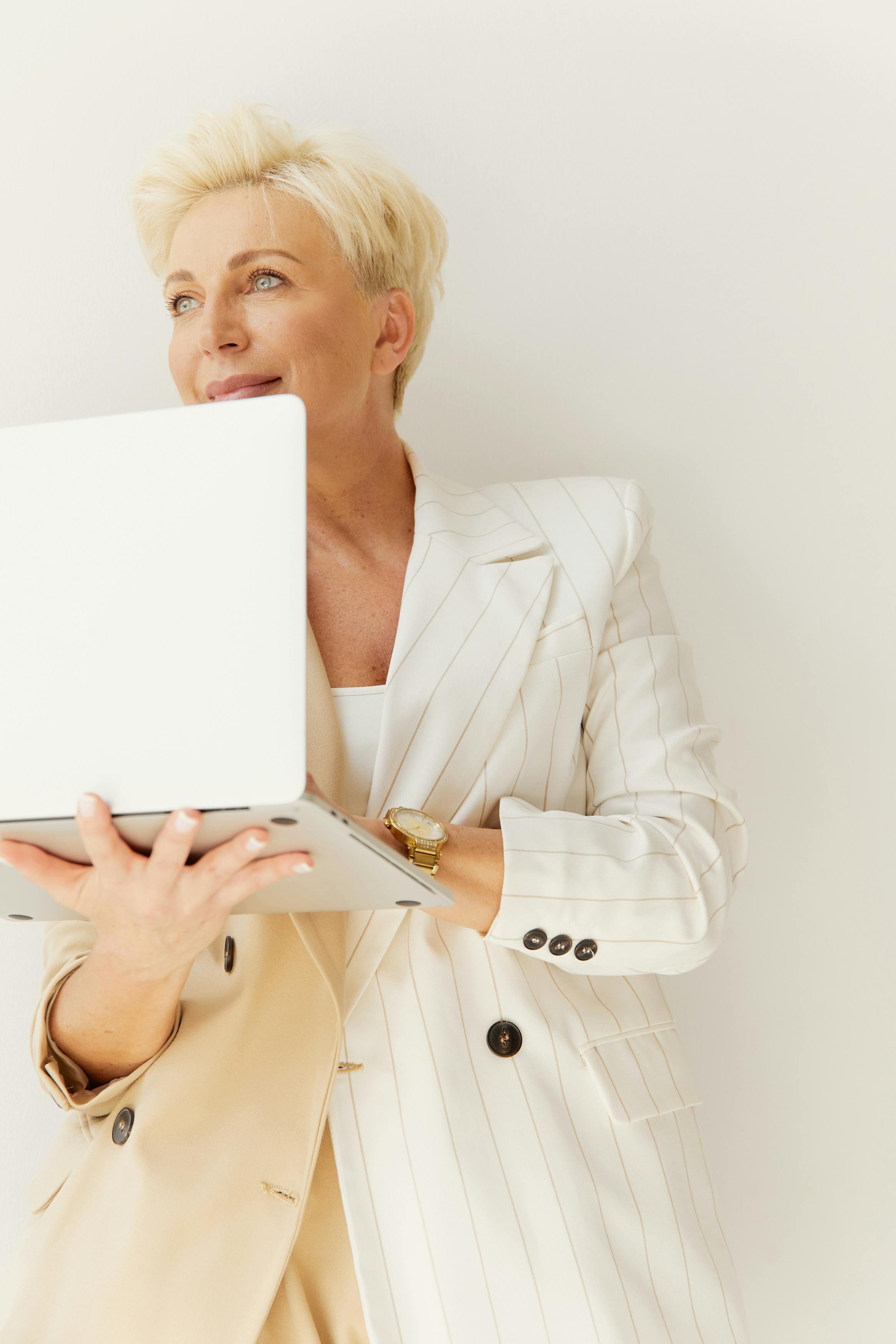 A generic picture of a woman holding a laptop.