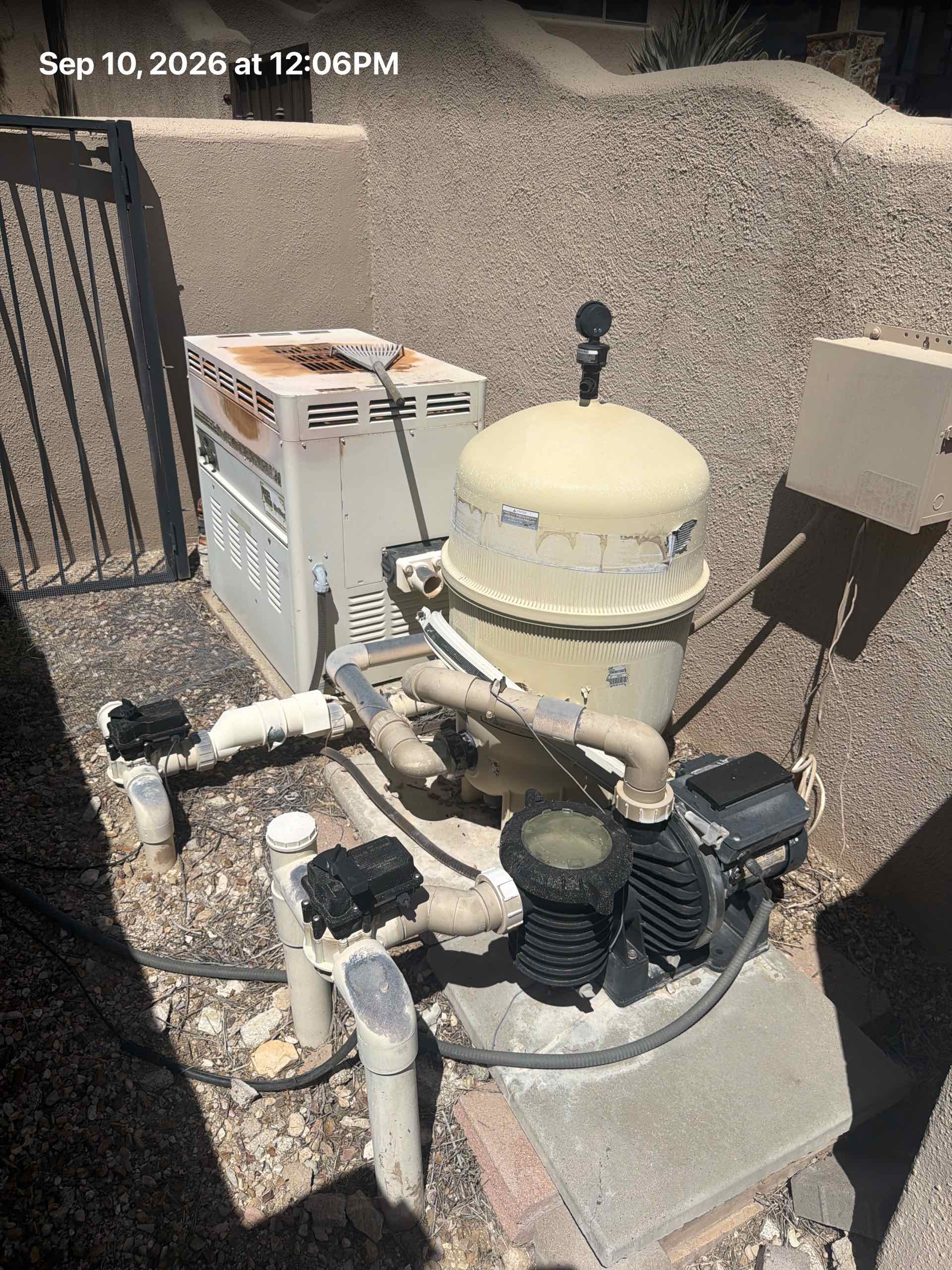 Old pool heater, automation panel, beige filter, and black pump on a concrete pad, stamped Sep 10, 2026.