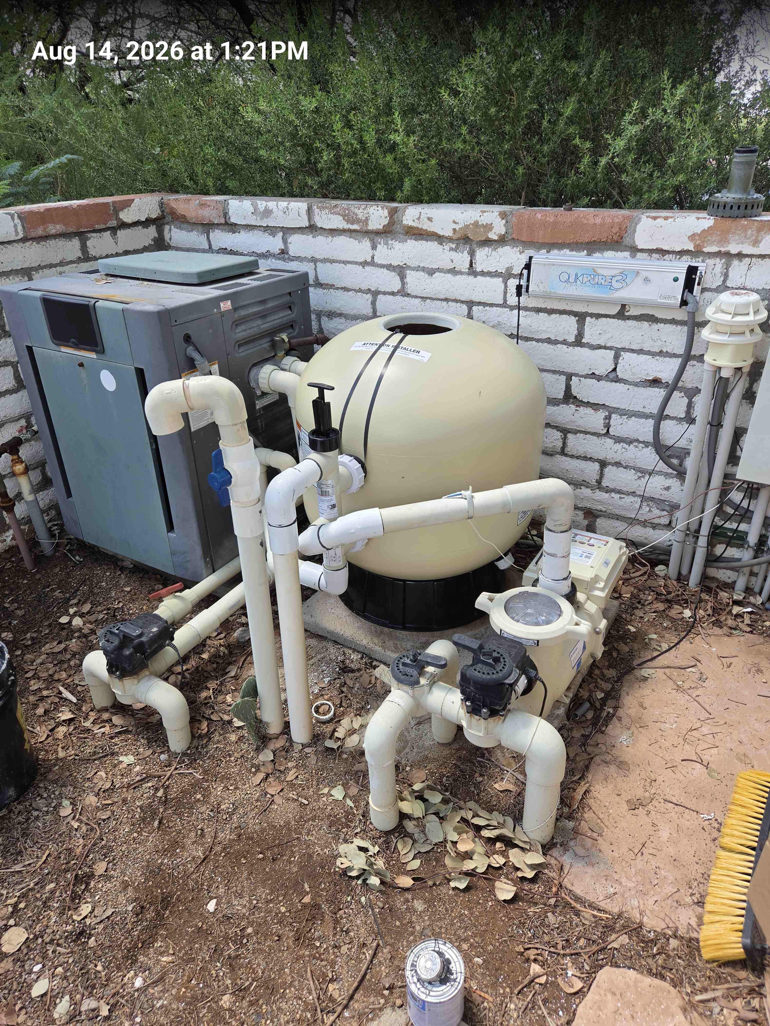 New sand filter tank installed back on the equipment pad, stamped Aug 14, 2026.