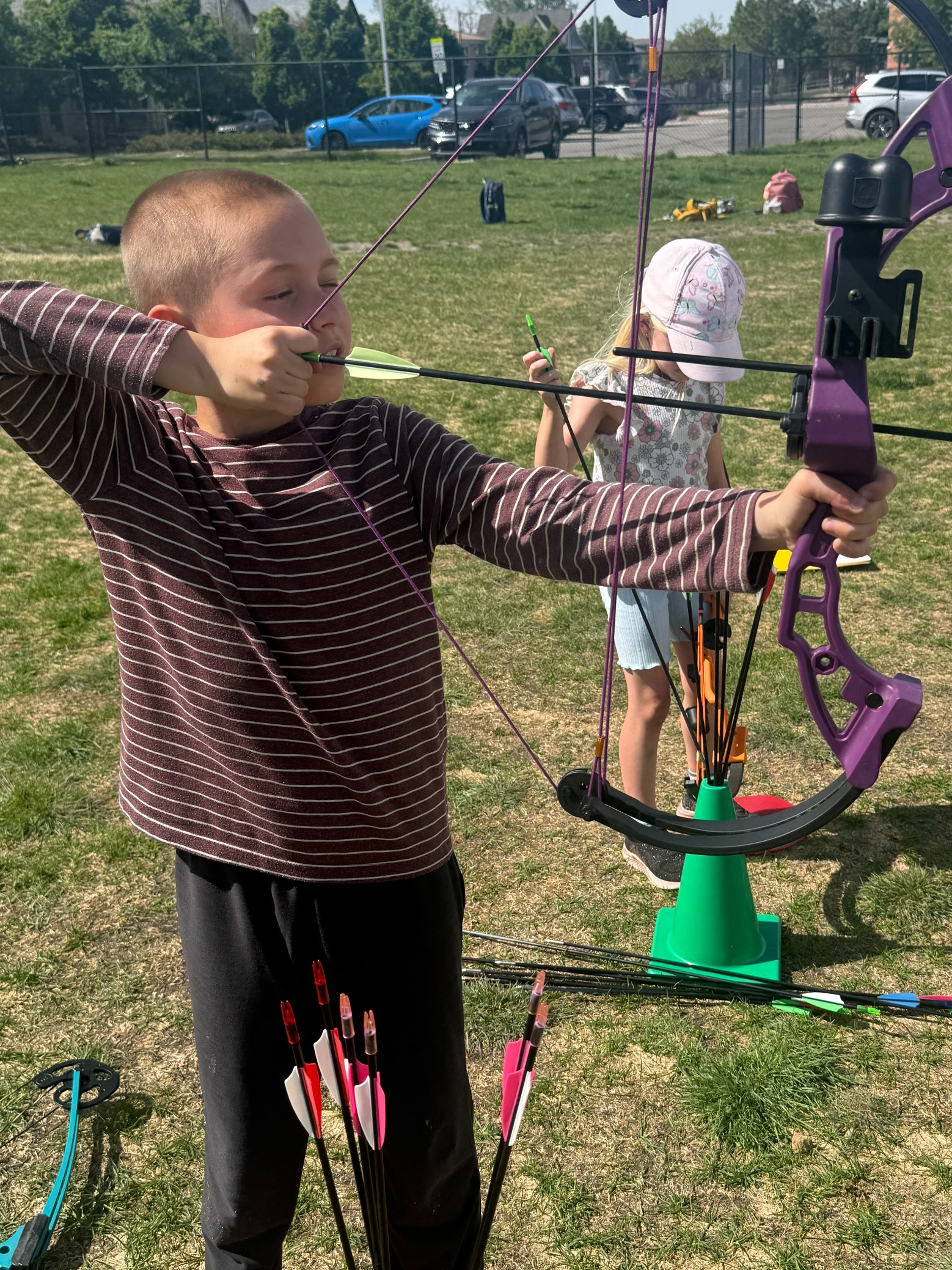 Instructor coaching a young archer