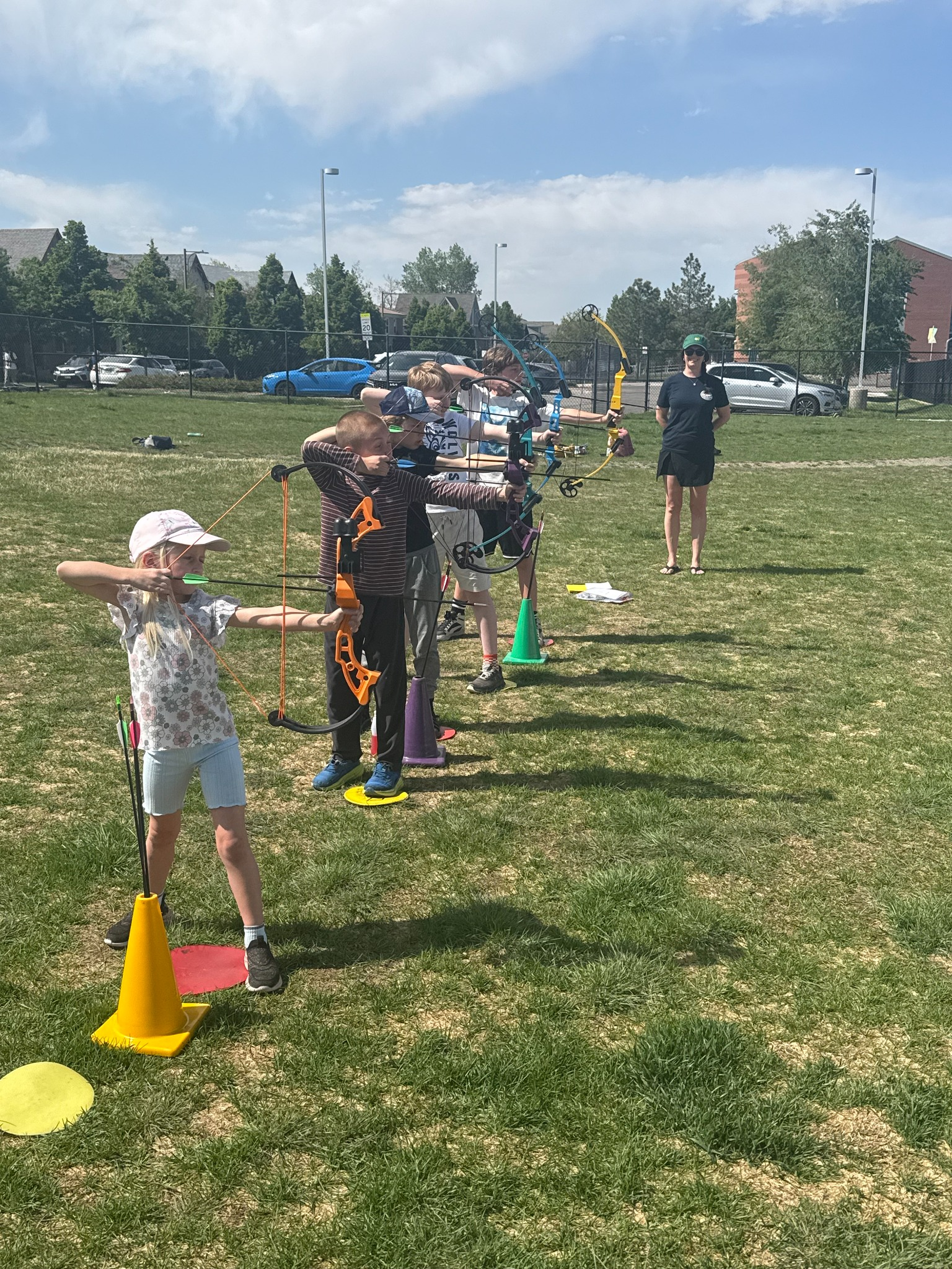 Students practicing archery outdoors