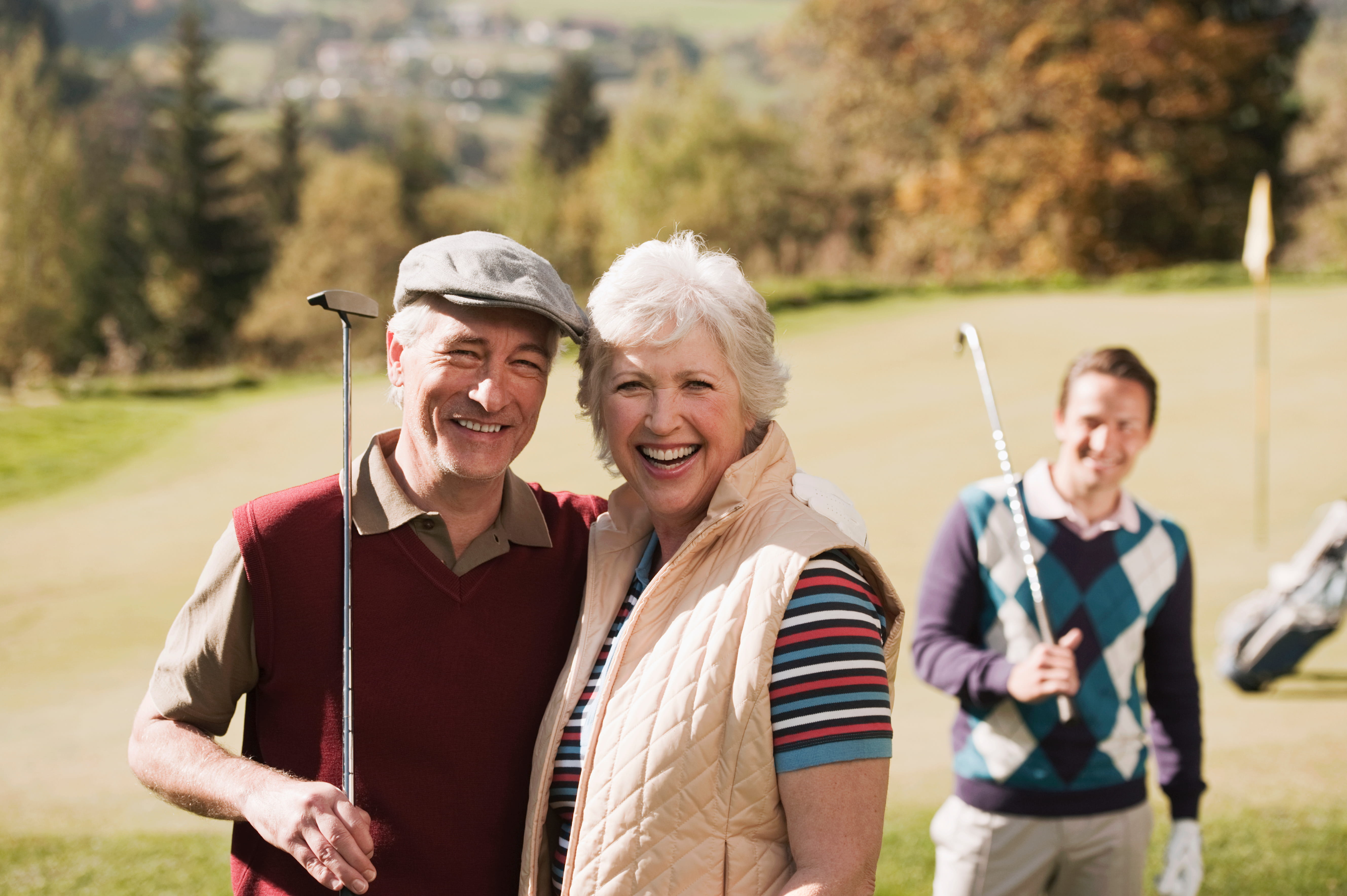 A group of smiling seniors enjoying time together outdoors
