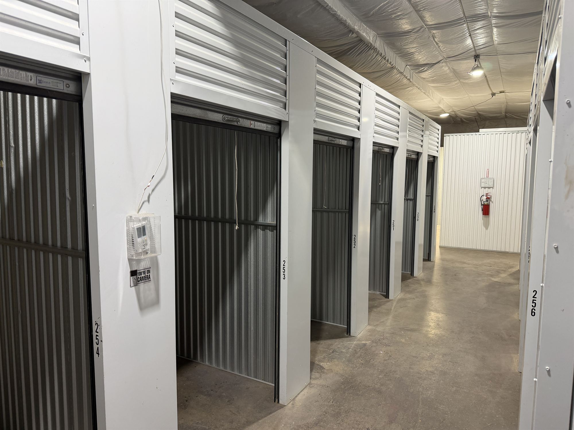 Interior hallway of temperature controlled units with a wall thermostat