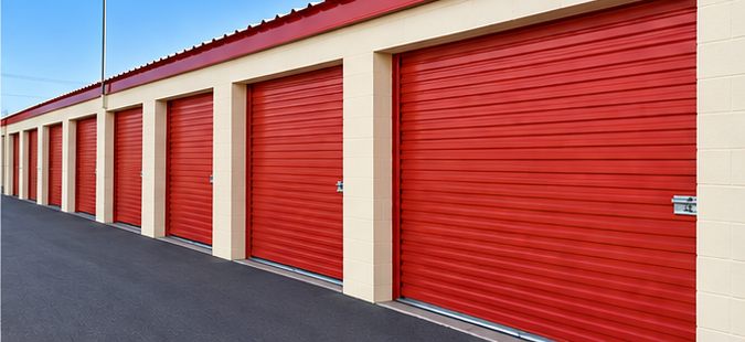 Drive-up storage units with wide red doors at CapRock Self Storage