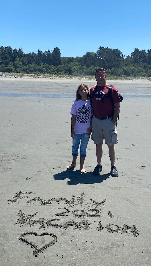 George and Taylor at the beach — Family Vacation 2021, heart drawn in the sand