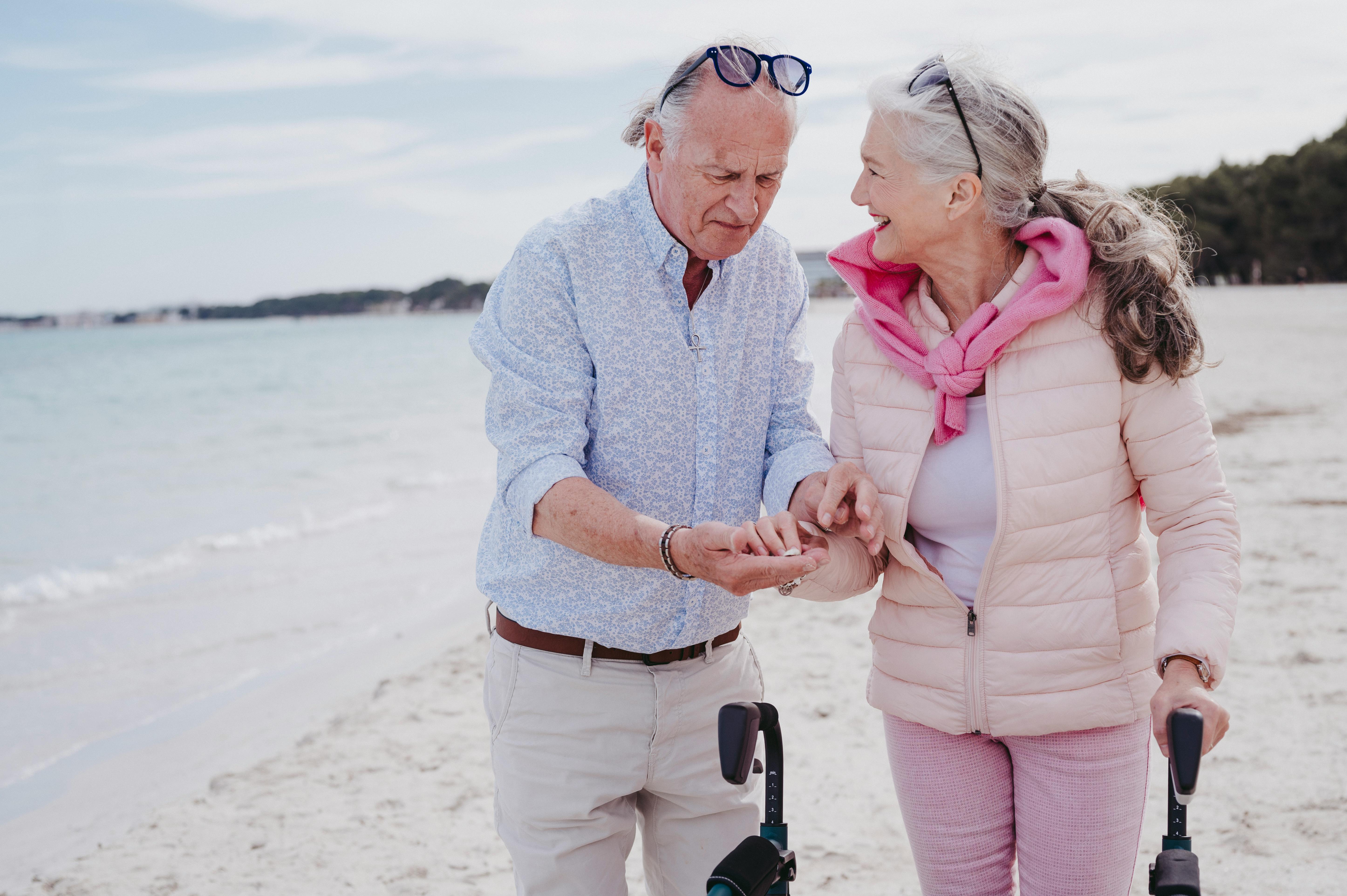 Elderly couple walking along the beach