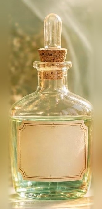 a wide bottle of pale green tincture with a cork stopper
