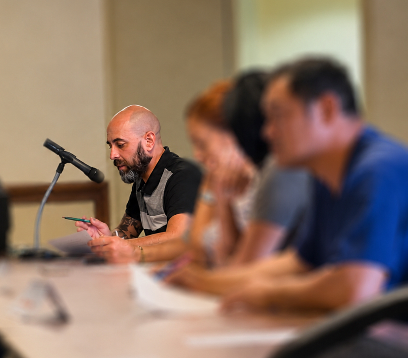 Anthony Armendarez speaking at a microphone at a public meeting