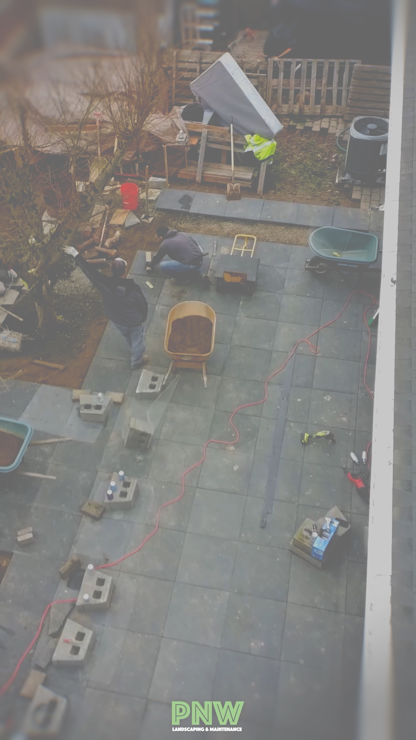 PNW Landscaping crew at work laying a paver patio in progress