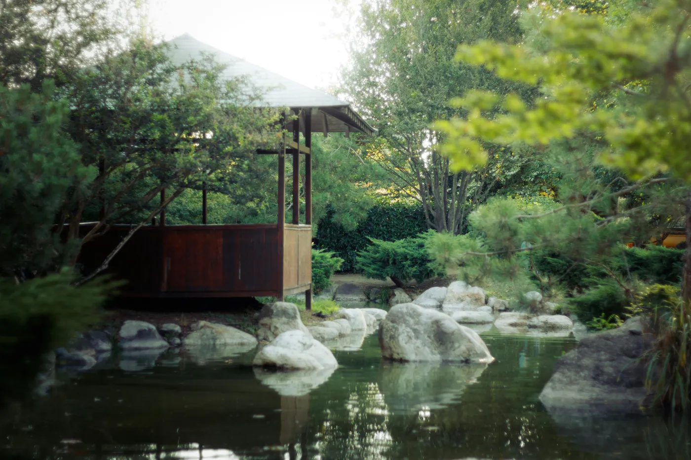A quiet garden pavilion beside a still pond