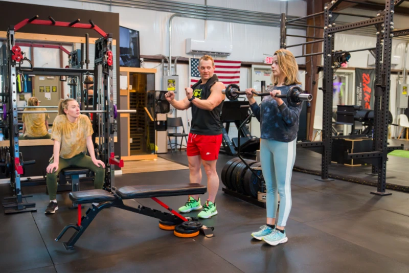 two women participate in small group training session led by trainer Jeff Caldwell at Yellow Brick Fitness in White House, TN