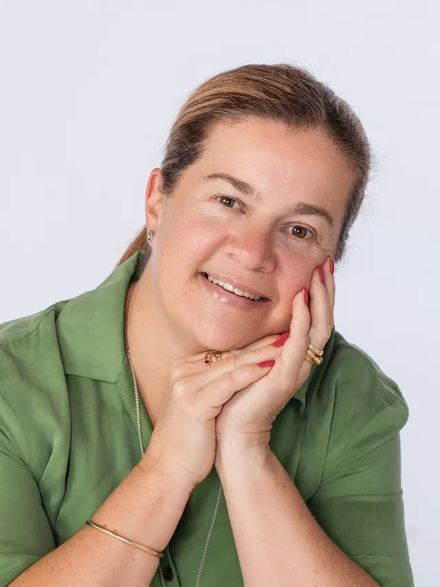 Tammy smiling with her chin resting on her hands