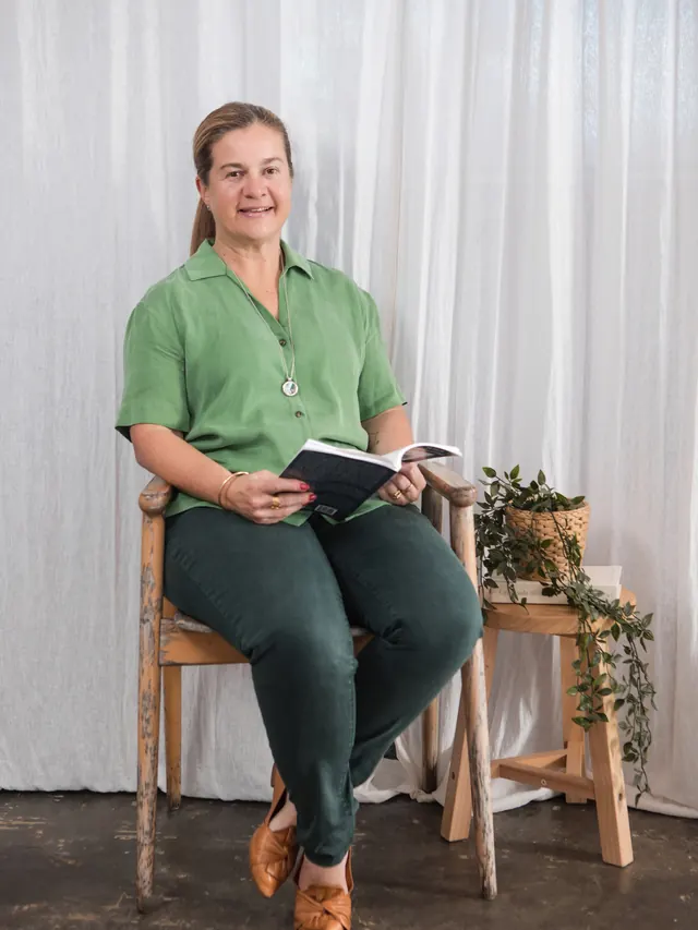 Tammy seated with an open book