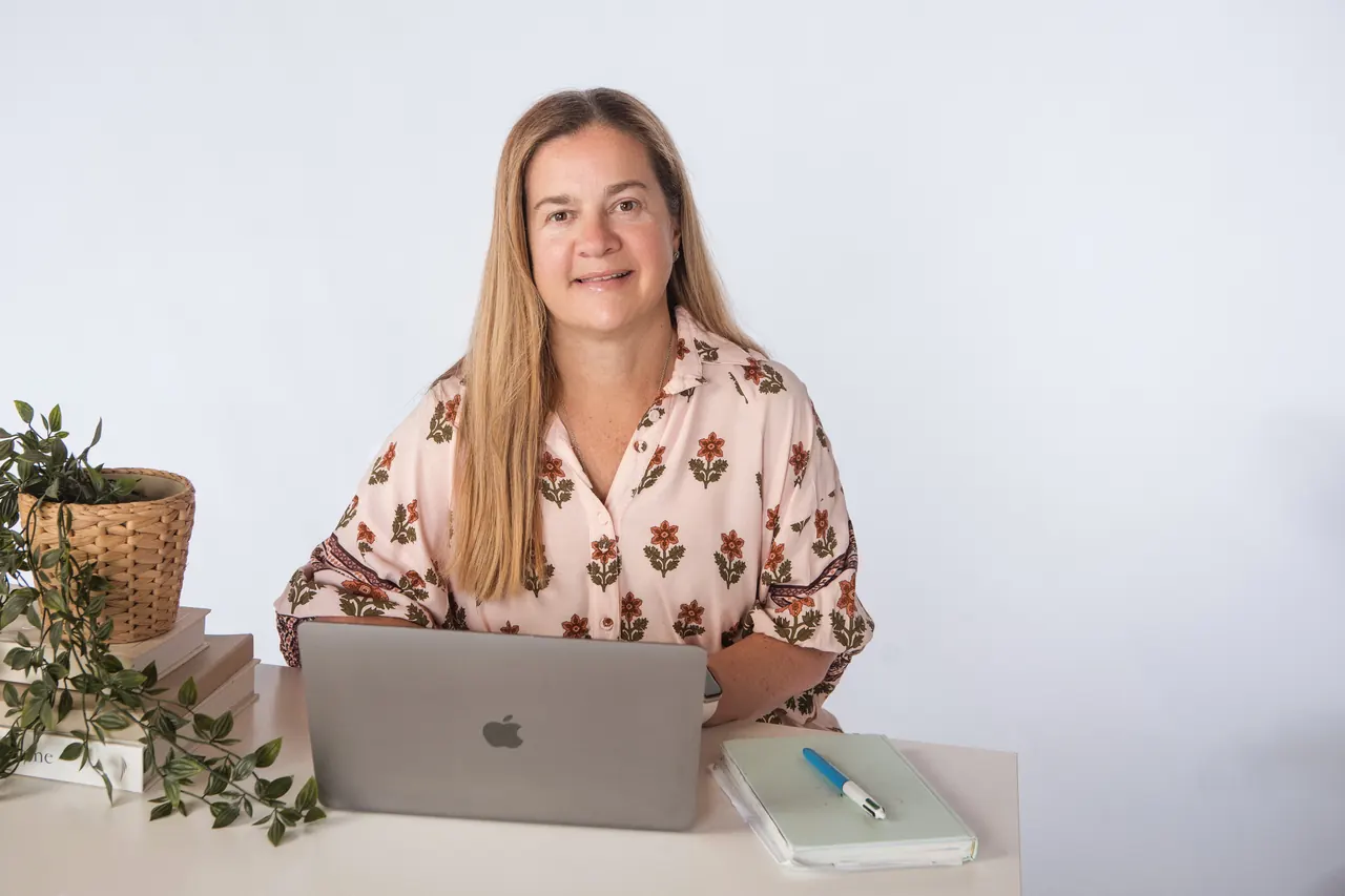 Tammy at her desk with a laptop, ready for a telehealth session