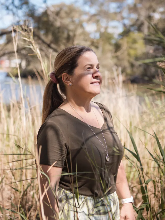 Tammy among the reeds by the water, looking out