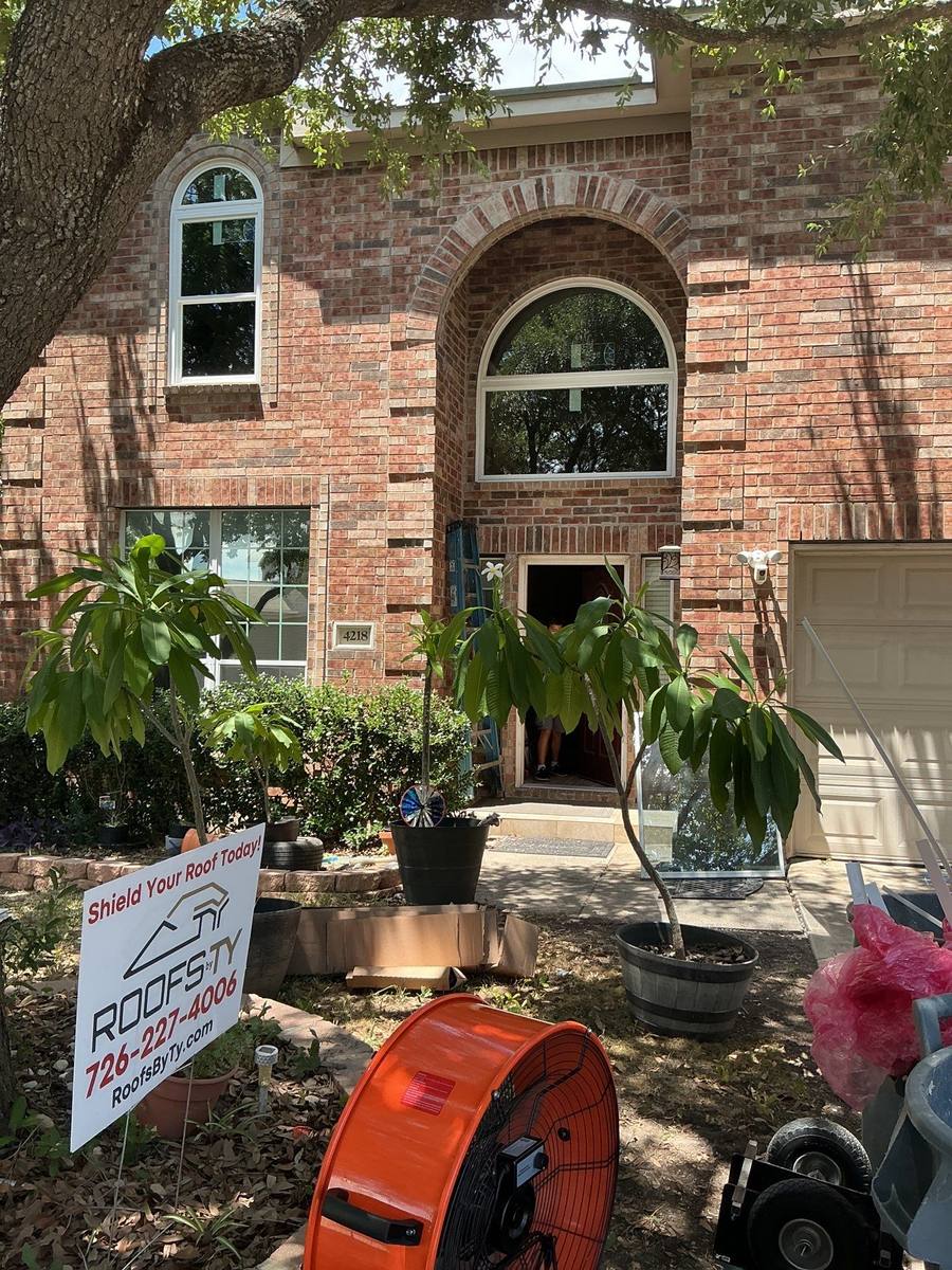 Roofs By Ty crew installing windows at San Antonio home