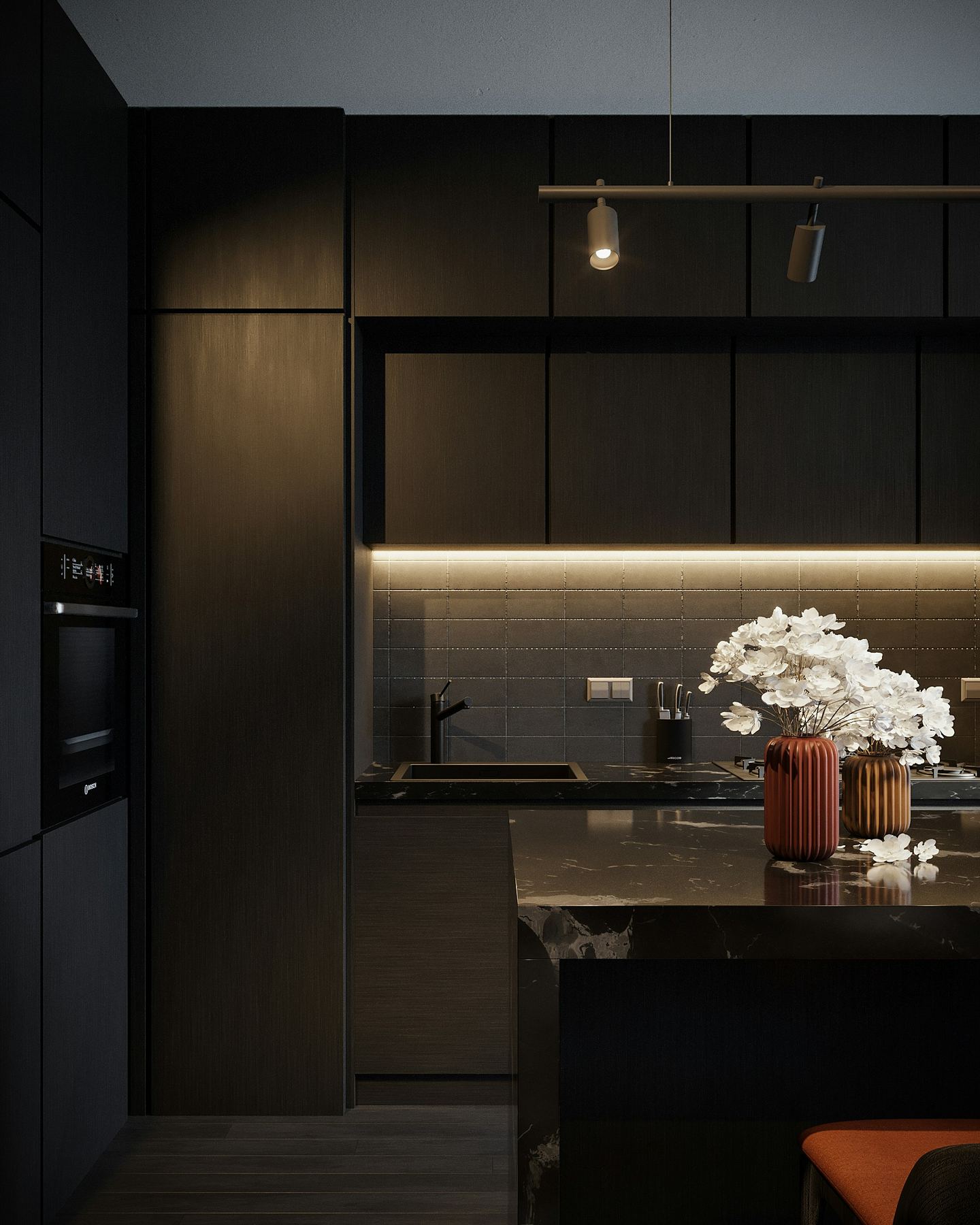 Matt black handleless kitchen with LED under-cabinet lighting (stock photo)
