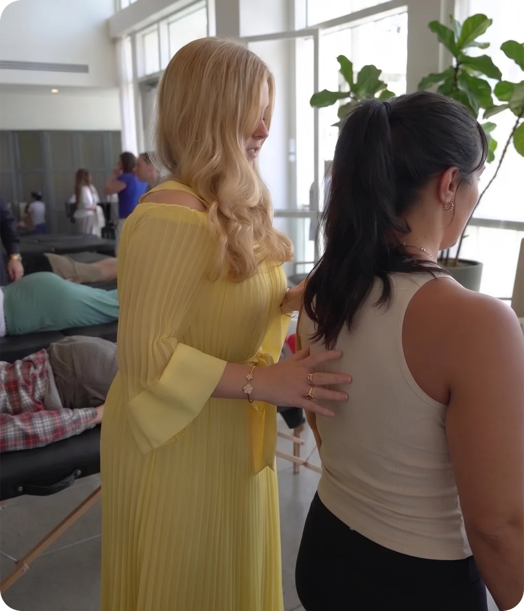 A practitioner delivering hands-on care to a guest at The Energy Gala