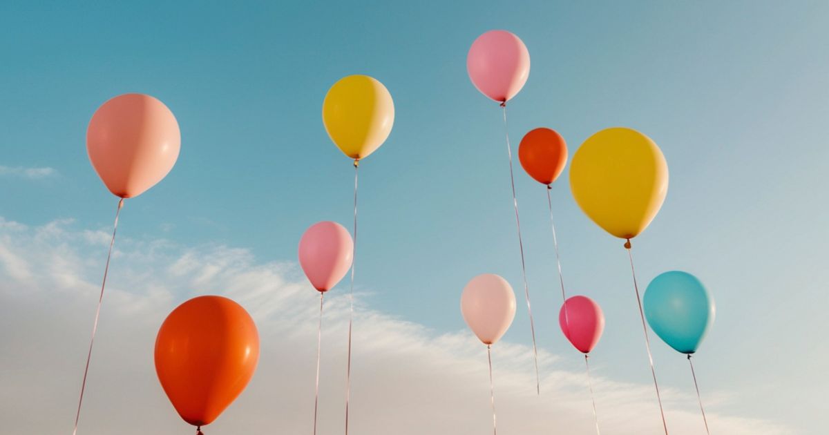 Colorful balloons rising into the sky representing midlife transition, personal growth, and letting go of what keeps you stuck