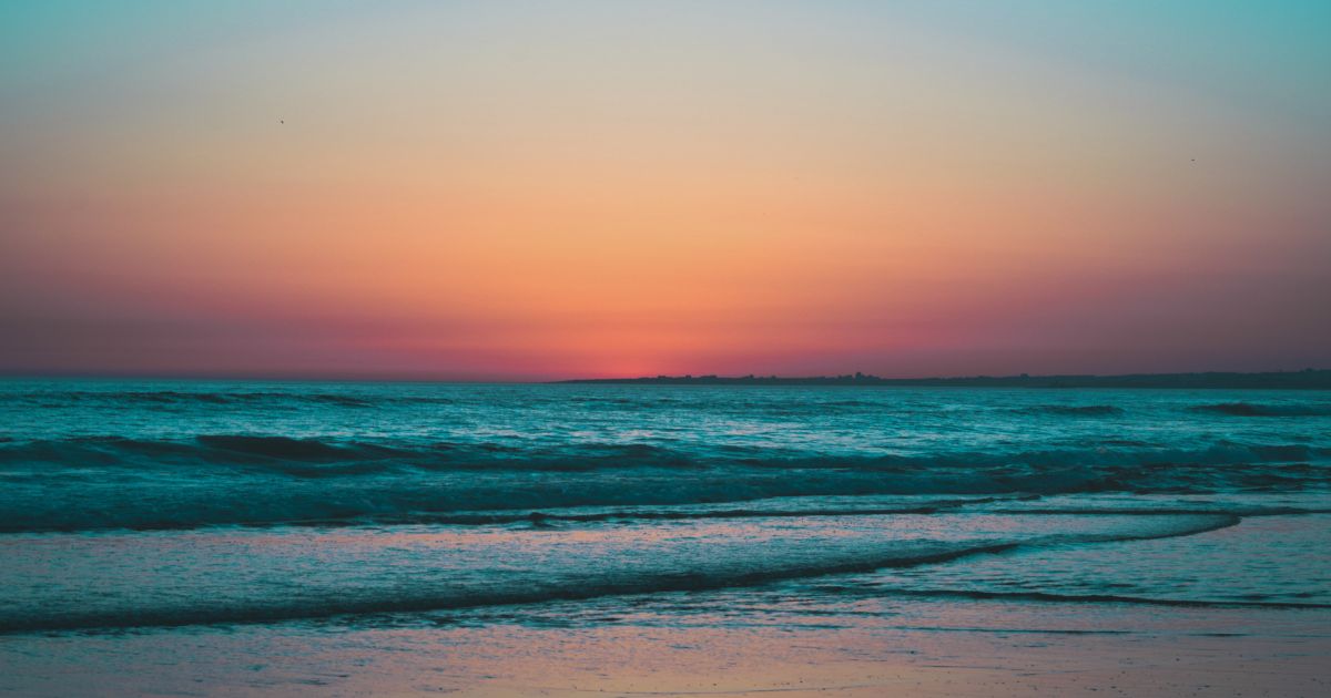 Calm ocean waves at sunset symbolizing reflection, healing, and emotional growth during a season of midlife transition
