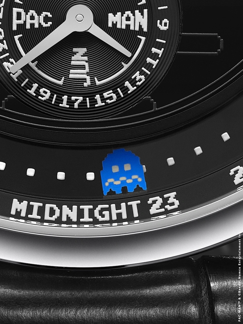 Detail of Krayon PAC-MAN dial showing hand-painted ghosts and fruit around the onyx disc