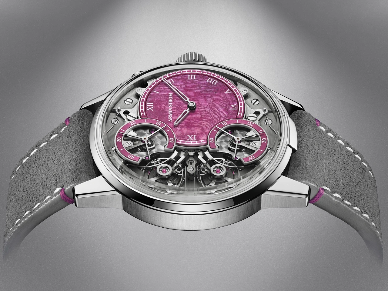 Wristshot of the Armin Strom Mirrored Force Resonance Ruby on grey Alcantara strap