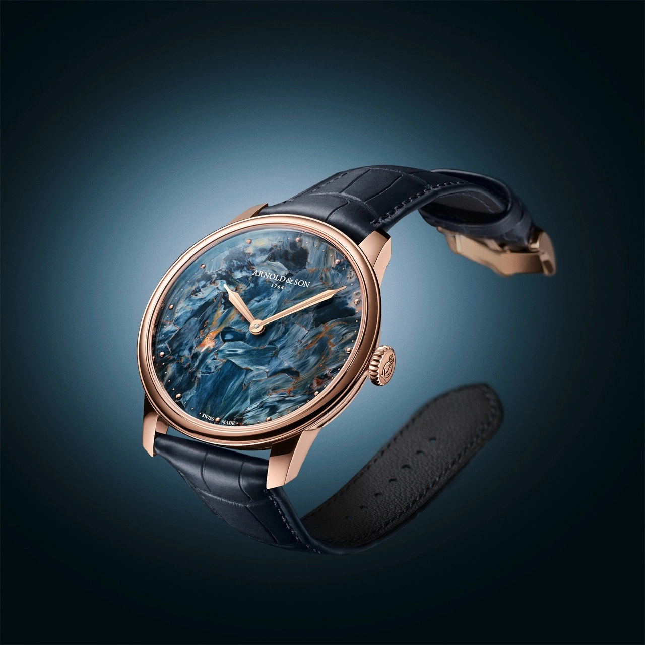 Close-up of the Arnold & Son HM Pietersite dial showing swirling stone-of-storms pattern