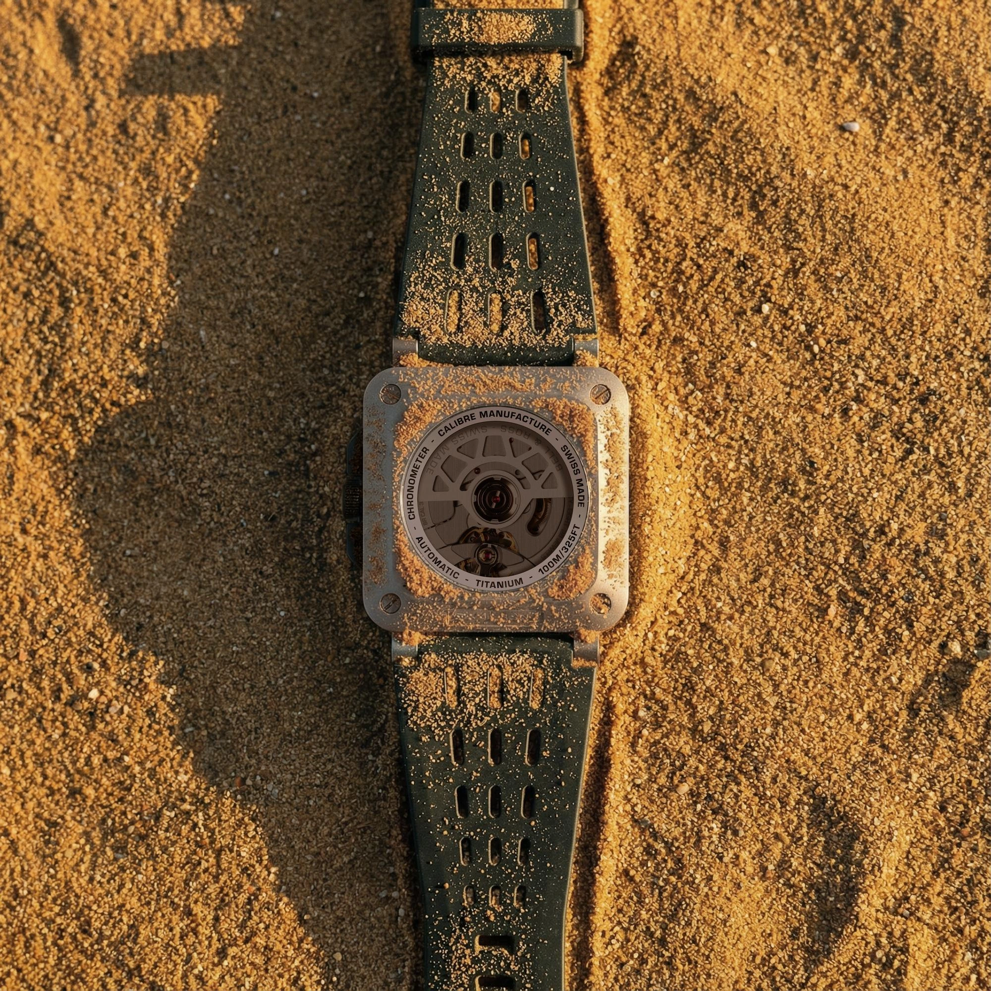 Bell & Ross BR-X3 Black Titanium watch alongside Defender rally vehicle in a desert setting
