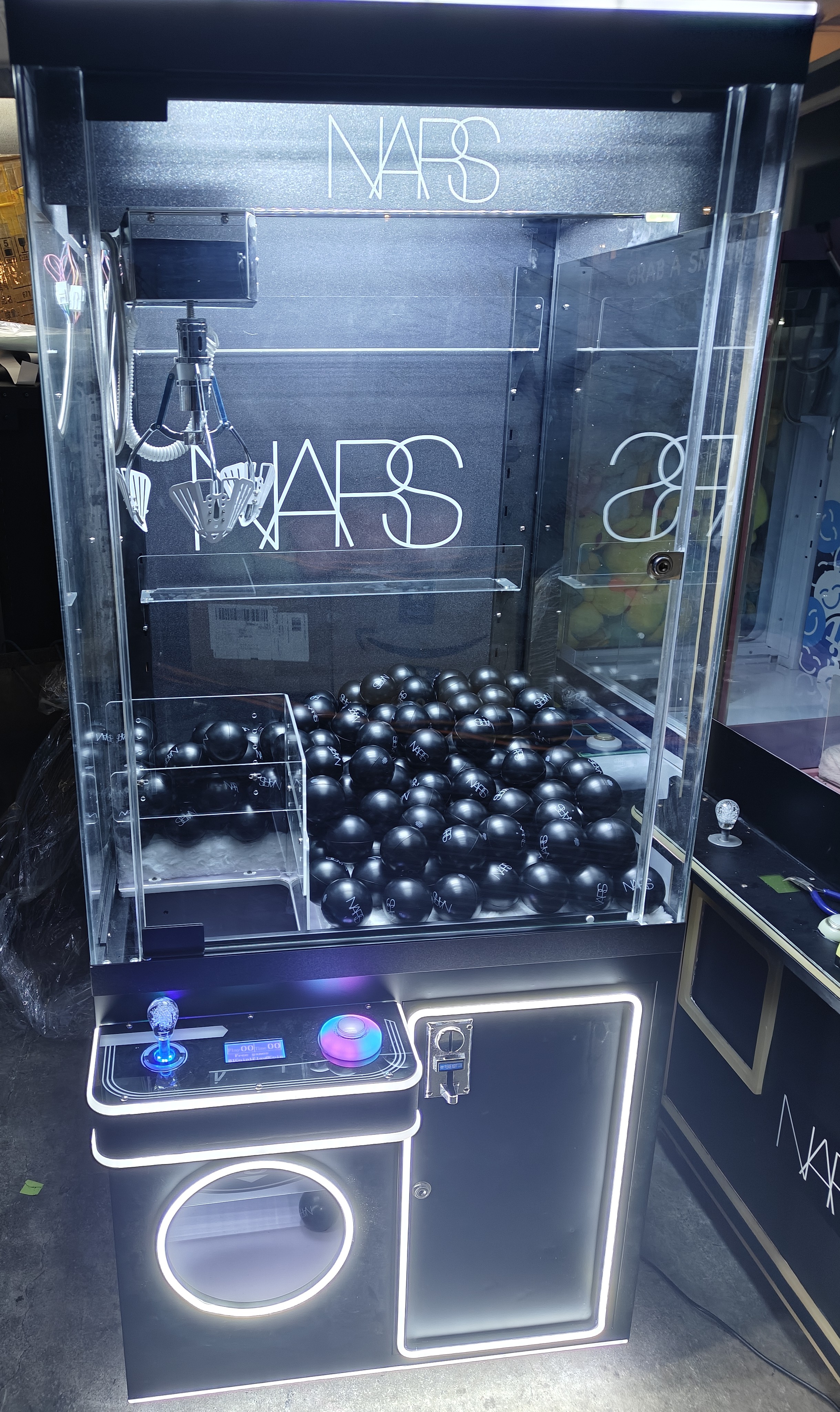 Branded claw machine event setup