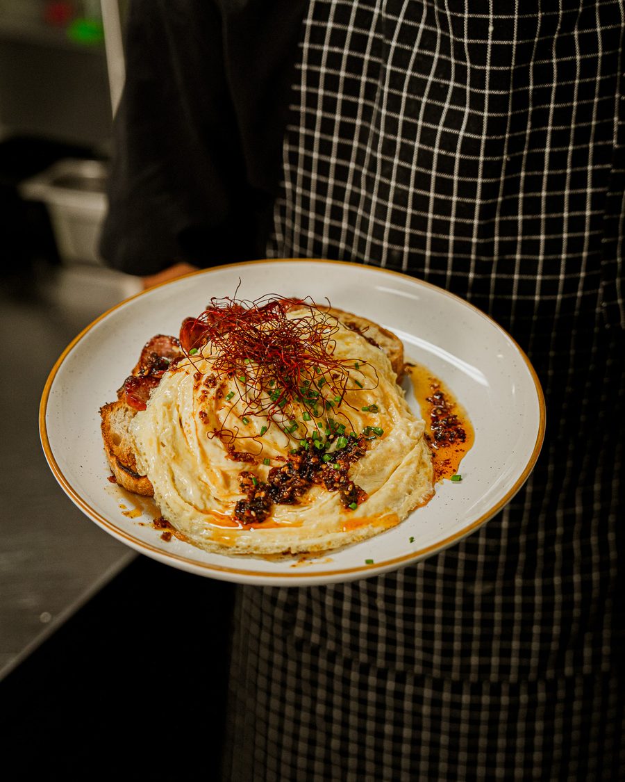 A Danka chef presenting a plate of Crispy Chilli Scrambled Eggs