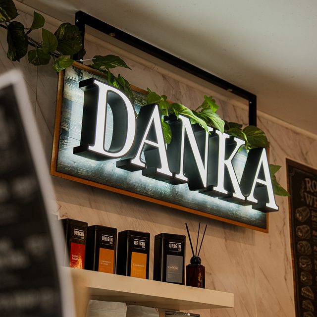 The DANKA neon sign above the coffee bar