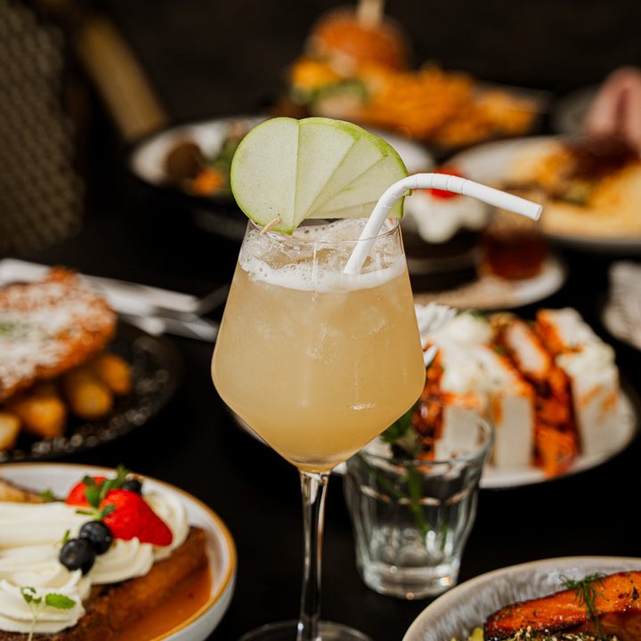 A Danka Special Sinking Dusk mocktail on a table full of brunch plates