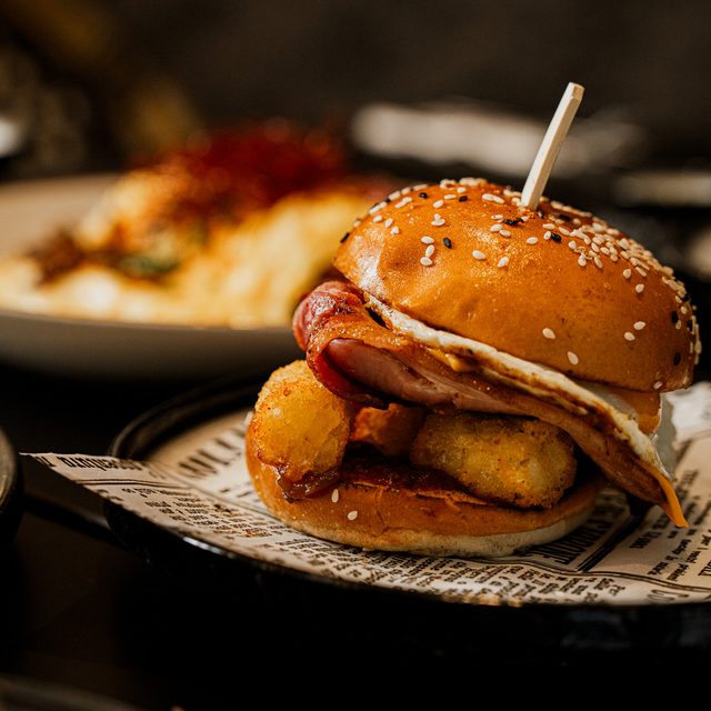 Brekky Roll with smoked bacon, fried egg and potato gems