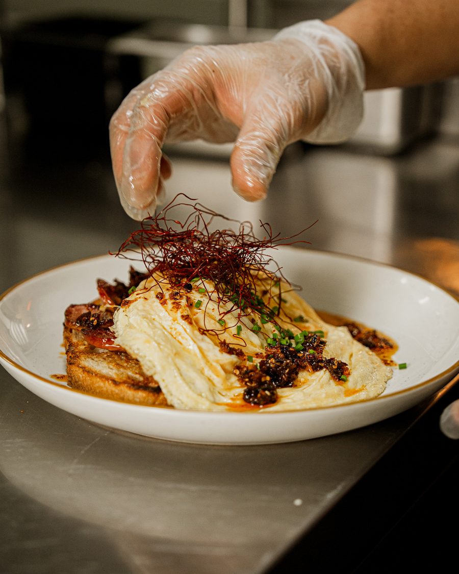 Crispy Chilli Scrambled Eggs being finished with chilli threads by a Danka chef