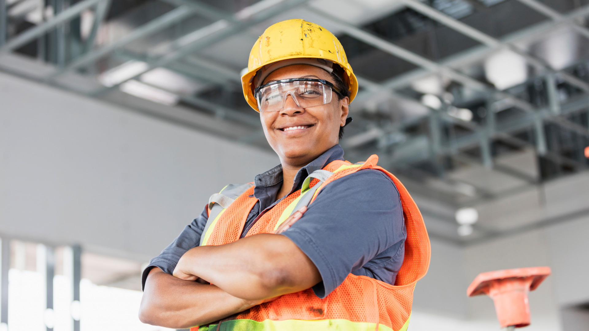 Construction worker reviewing blueprints at a building site